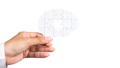 Hand holds brain shaped puzzle piece with missing section symbolizing business problem solving in transparent PNG format