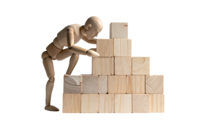 Wooden mannequin pushes wooden blocks in business concept PNG image symbolizing effort and progress