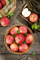Fresh Red Fuji Apples from Yunnan China in Rustic Wicker Baskets on Wooden Table