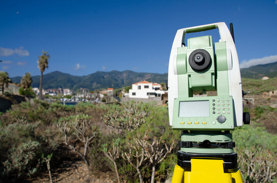 Digital total station on tripod for geospatial data collection in construction and land surveying applications.