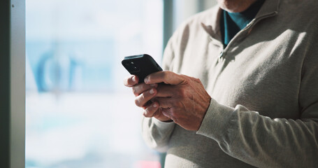 Typing, hands and man in office with phone, email feedback or communication in finance company. Text, business and person in workplace with technology, document download or checking meeting schedule.