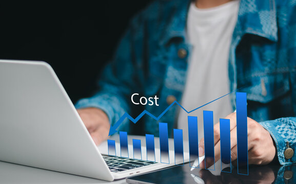 Businessman pointing at analysis financial graph while reduce cost of  business to gain more revenue and profit with better productivity. Lean process and budget cut in corporate with technology.