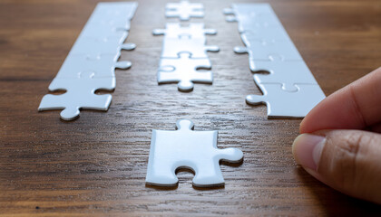 Personnel, employment and recruitment concept. Assembling jigsaw puzzle on wood desk.Human resource management