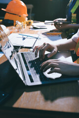Closeup of team of industrial engineers meeting analyze machinery blueprints consult project on table in manufacturing factory. Working in manufacturing plant or production plant.