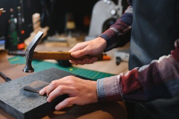 Banner tailor industry craftsman. Leather rolls and tools for handmade craft in workshop