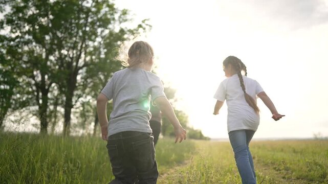 Child run along grass path toward bright sun while sunlight warms field and nature friendship growing as child play in outdoor meadow with grass path leading into open field under golden light