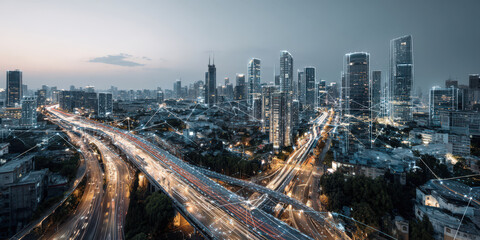 Obraz premium Futuristic cityscape at dusk showcases network of illuminated skyscrapers and highways, symbolizing digital transformation and smart city infrastructure. scene conveys innovation and connectivity