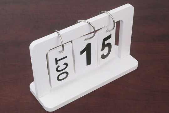 October, 15 on calendar on wooden background.	