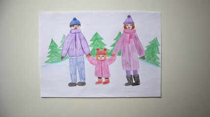 Child's drawing family on winter walking. Parents and their daughter are standing hand in hand against snowy landscape with fir trees. Dressed in warm winter clothes. Colored pencils. White background