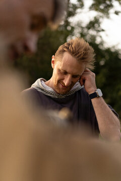 Thoughtful Man With Beard Looking Down Outdoors In Natural Light