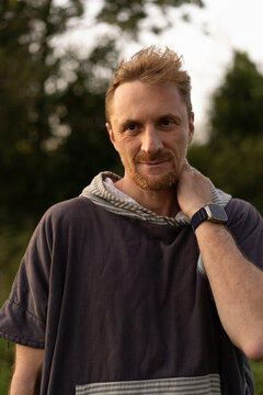 Relaxed Man With Beard Wearing Hoodie Outdoors In Natural Setting