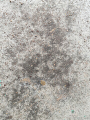 Close-up of weathered concrete surface with stains and textures.