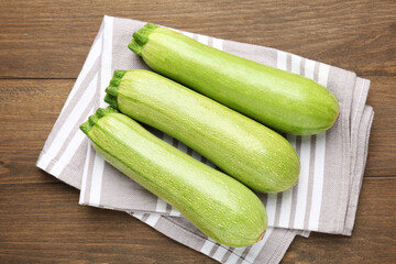 Fresh ripe zucchinis on wooden table, top view
