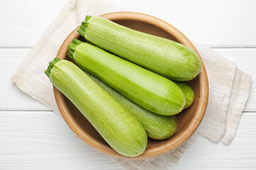 Fresh ripe zucchinis on white wooden table, top view