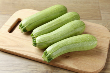 Fresh ripe zucchinis on wooden table, closeup