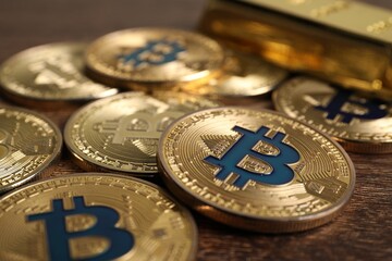 Cryptocurrency. Bitcoins on wooden table, closeup view