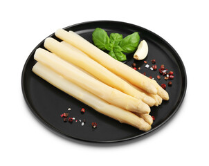 Spears of pickled asparagus with spices isolated on white