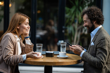 Business people having coffee break using mobile phone and talking