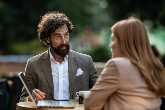 Business partners discussing strategy during an outdoor meeting