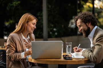 Business people having a productive meeting at outdoor cafe
