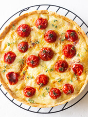 Quiche with cheese, tomatoes, and thyme. Pie. Pastries. Vegetarian food.