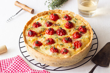 Quiche with cheese, tomatoes, and thyme. Pie. Pastries. Vegetarian food.