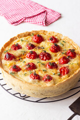 Quiche with cheese, tomatoes, and thyme. Pie. Pastries. Vegetarian food.