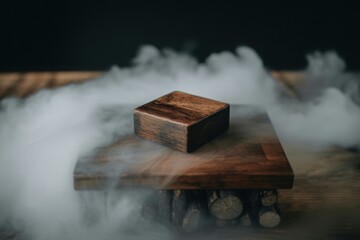 Rustic wooden cube on wooden platform with atmospheric smoke mist