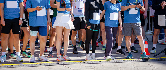 Large group of athletes waiting at marathon start line