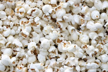 Large group of fresh cooked popcorn displayed for sale at a street food market