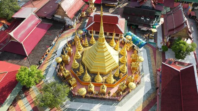 A large chedi temple surrounded by smaller golden chedis