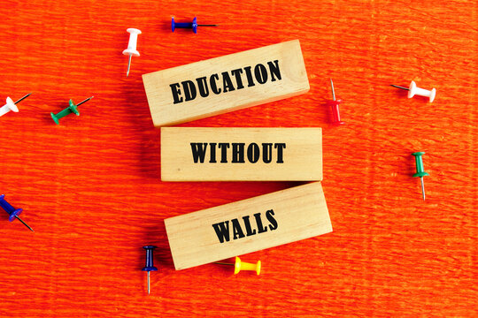 Education concept. EDUCATION WITHOUT WALLS words assembled from wooden blocks in a composition with stationery pins on an orange provocative background, top view - Powered by Adobe