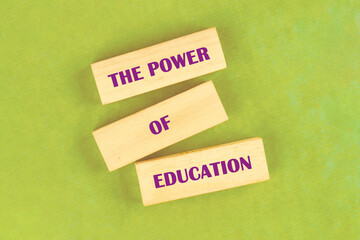 Business and Words Matter concept. Copy space. THE POWER OF EDUCATION assembled from blocks on a light green background, top view