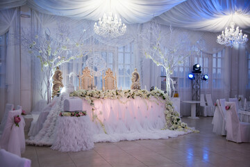 Elegant wedding reception setup with floral decorations and soft lighting