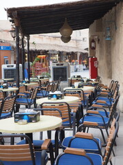 A lively, inviting outdoor cafe in a bustling market, a perfect spot to relax.