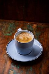 Cup of coffee on rustic wooden background. Soft focus. Copy space	