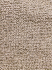 Close up of beige textured terry cloth fabric background
