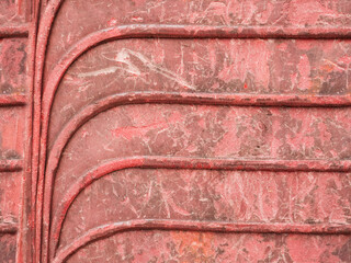 Repeated curves pattern of old stacked plastic chairs