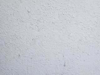 White textured plaster wall surface with subtle roughness