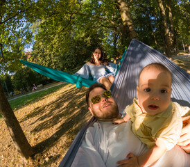 Family Relaxing in Hammocks at the Park