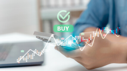 Investor using smartphone with cryptocurrency trends, buy sell trading signals, digital investment, and fintech technology for global financial growth.