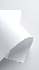 Abstract close-up of two sheets of white paper, curved and overlapping