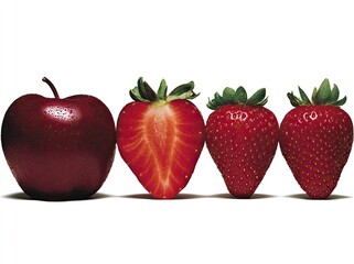 Red apple and strawberries in a row against white