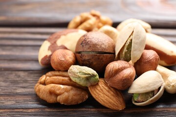 Mix of different nuts on wooden table, closeup