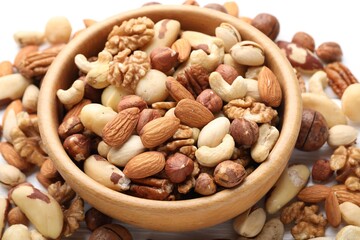 Mix of different nuts in bowl on table, closeup