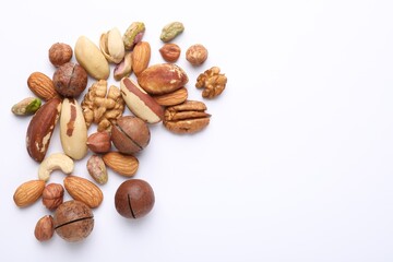 Mix of different nuts on white background, flat lay. Space for text