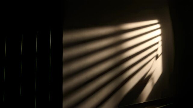 Louvered Slats Spin Bars Across Charcoal Wall