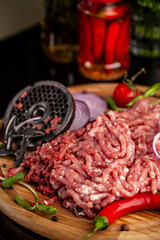 Fresh raw minced pork with grinder plate and spices