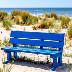 Blue bench on sandy beach by ocean
