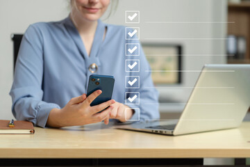 Fototapeta premium Business woman using tablet to do online checklist survey, doing assessment online survey answer test questions Digital form.